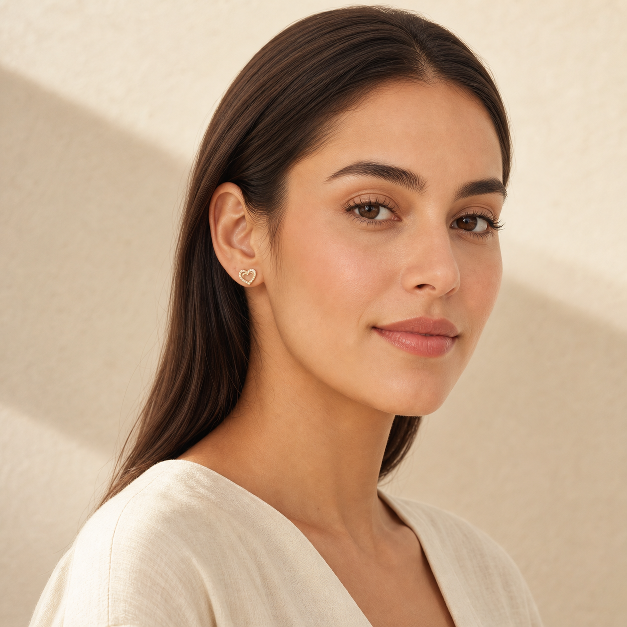 Petite Heart Stud Earrings worn in a lifestyle portrait